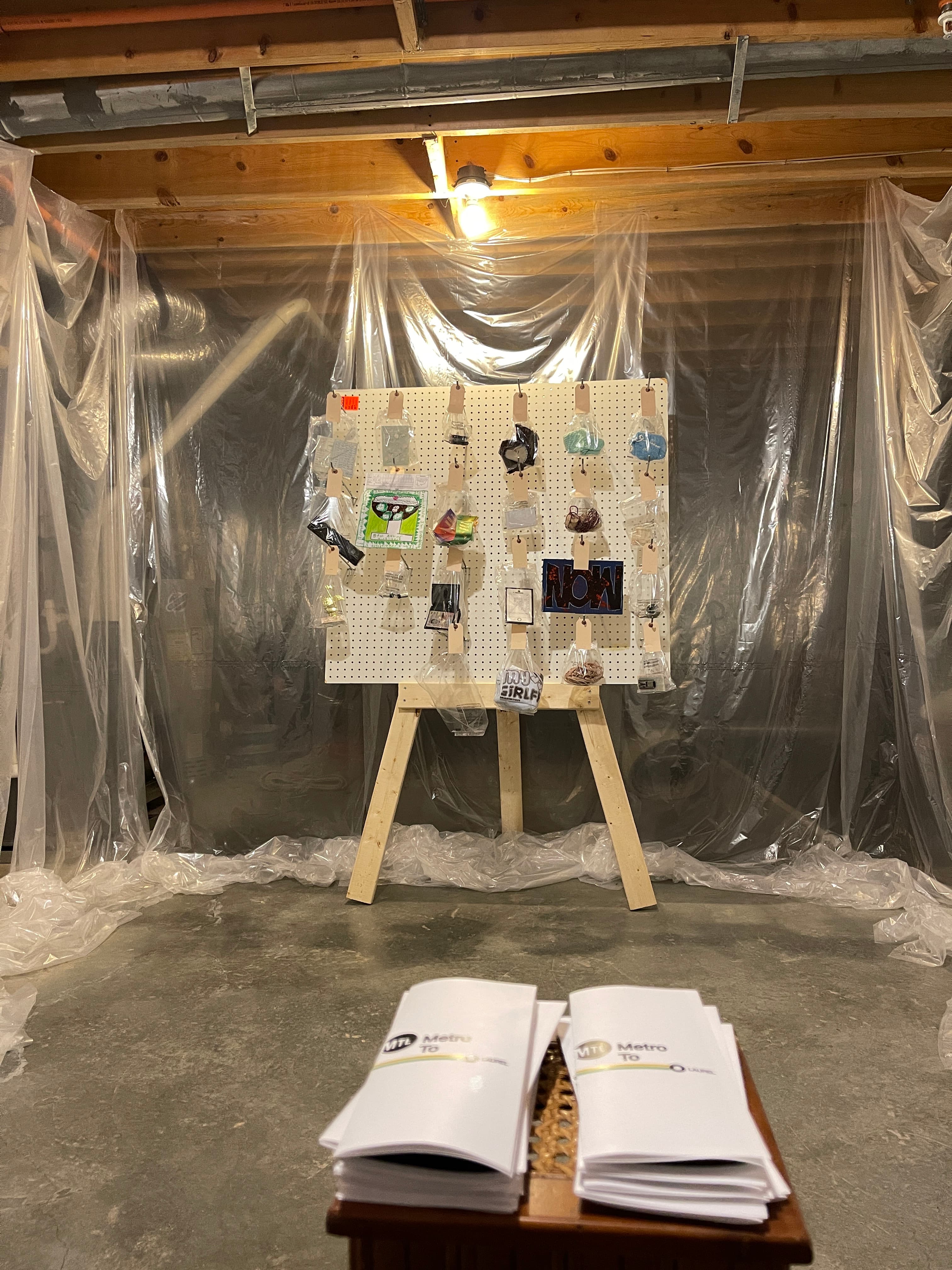 Artwork displayed on a pegboard inside the first MTL basement gallery.